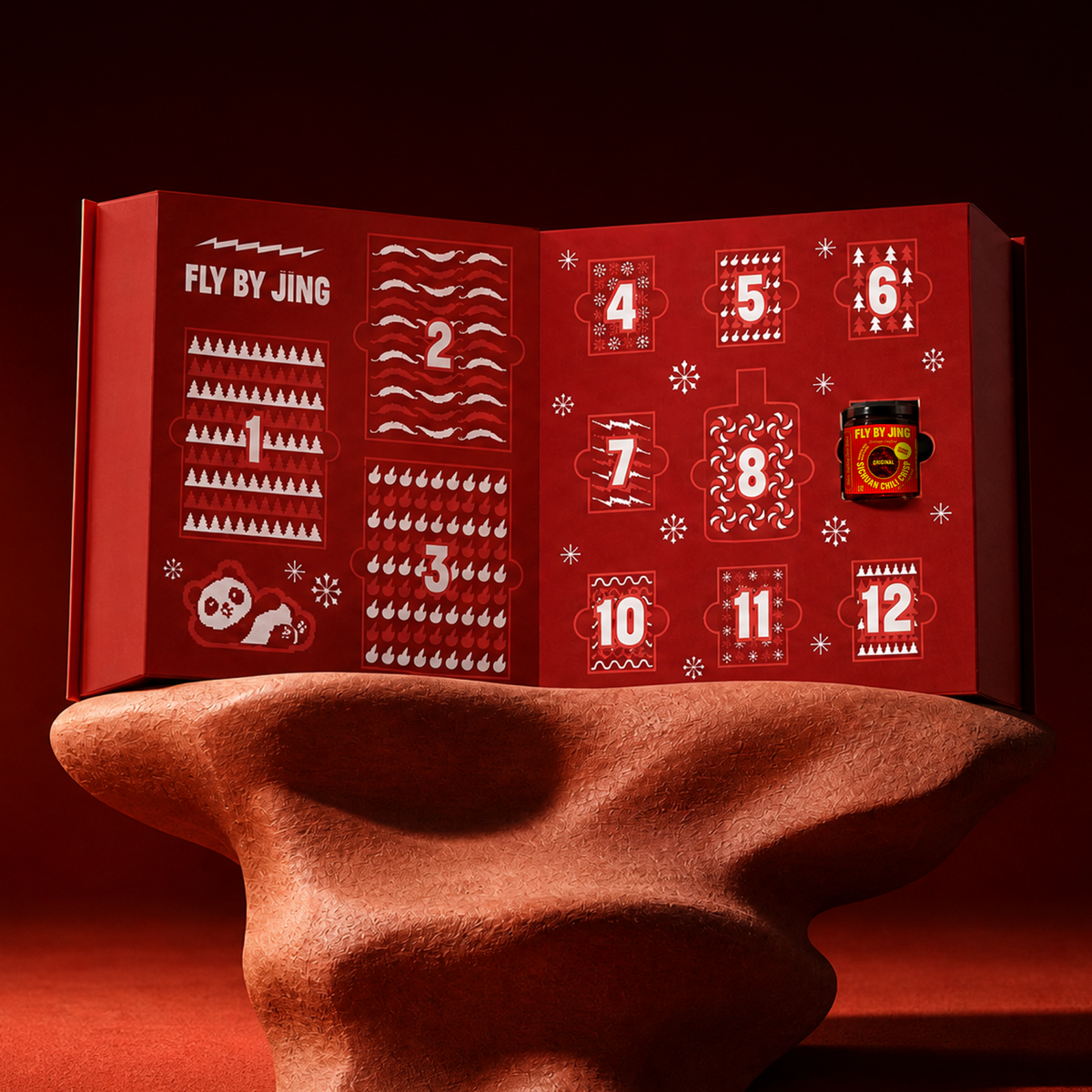 Fly By Jing 2026 Advent Calendar open showing 12 numbered doors with Sichuan panda and Chili Crisp jar
